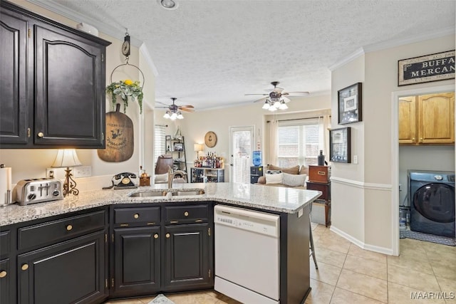 kitchen with washer / dryer, sink, white dishwasher, kitchen peninsula, and light stone countertops