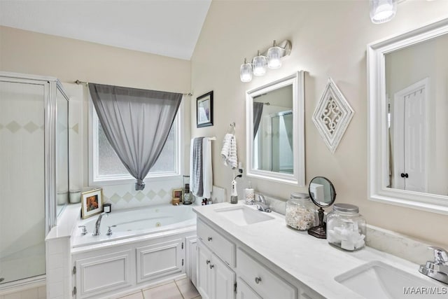 bathroom featuring independent shower and bath, vanity, and tile patterned flooring