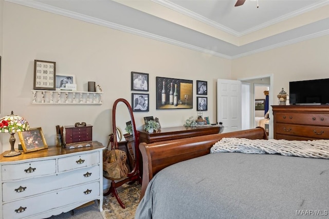 bedroom featuring crown molding, ceiling fan, and a tray ceiling