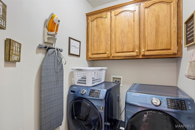 washroom with cabinets and independent washer and dryer