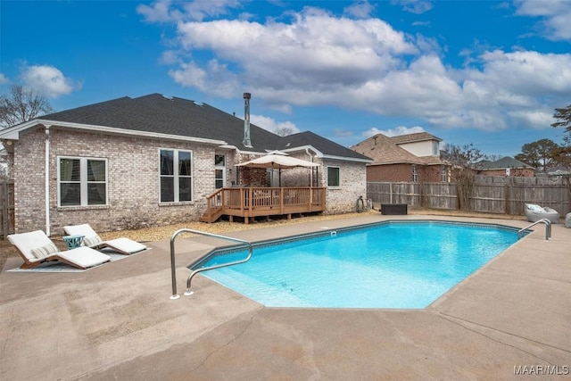 view of pool featuring a wooden deck and a patio