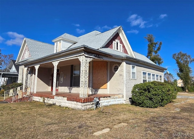 view of home's exterior with a yard and covered porch