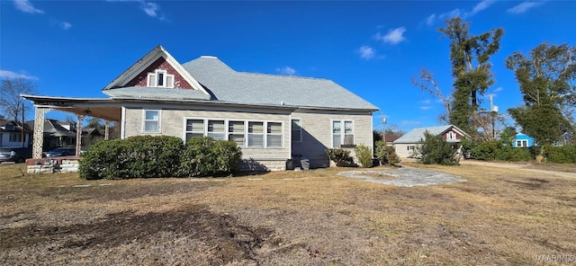 rear view of property featuring a yard