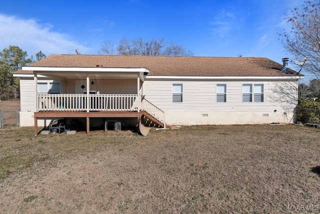 rear view of property with a yard and a deck