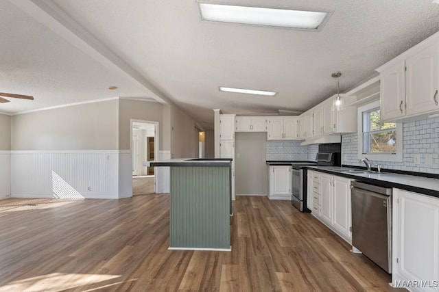 kitchen featuring stainless steel appliances, sink, dark wood-type flooring, and white cabinets