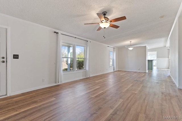 unfurnished room with ceiling fan, light hardwood / wood-style flooring, and a textured ceiling