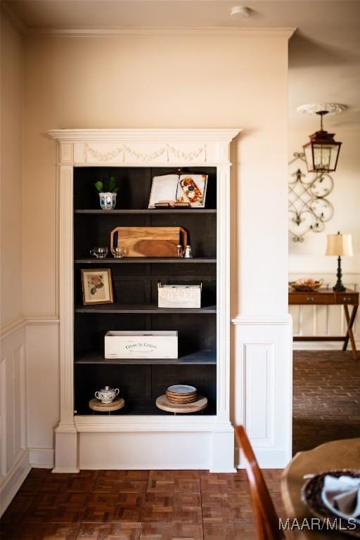 interior details with crown molding and parquet flooring