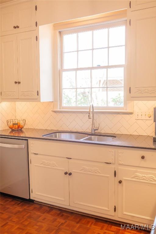 kitchen featuring white cabinetry, dishwasher, sink, and dark parquet flooring