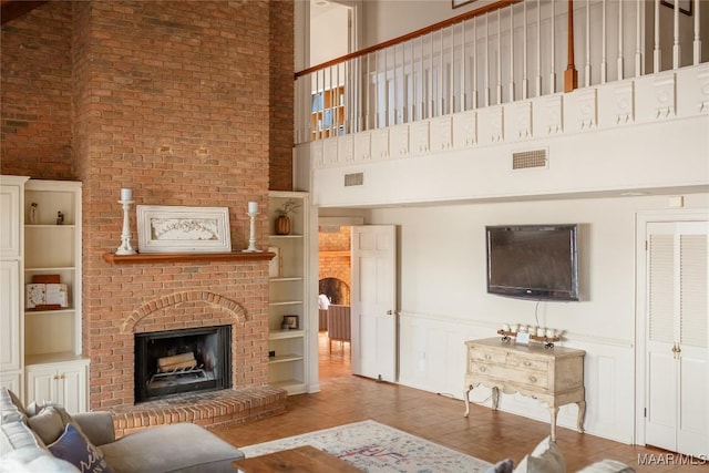 living room featuring a fireplace and built in shelves