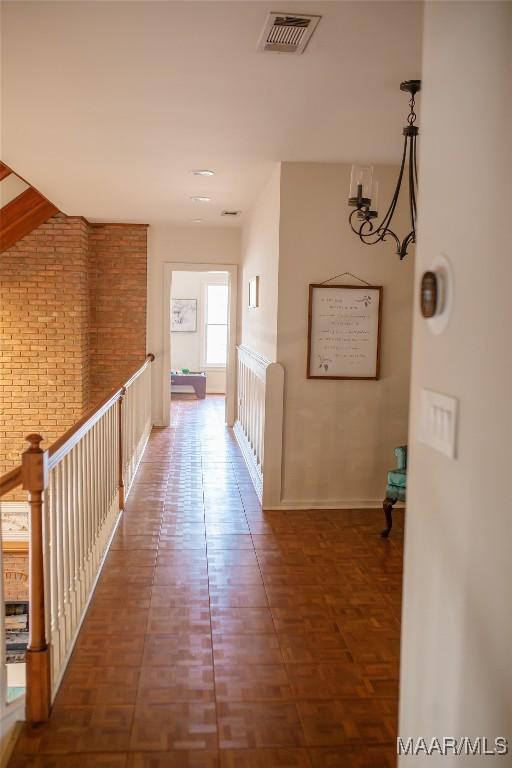 hallway featuring brick wall