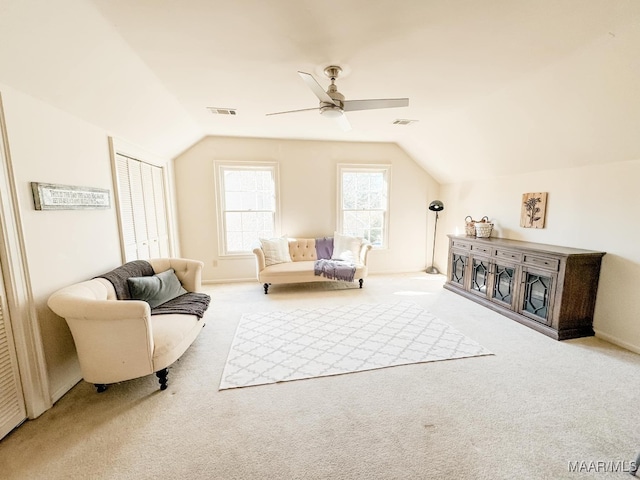 living area with vaulted ceiling, light carpet, and ceiling fan