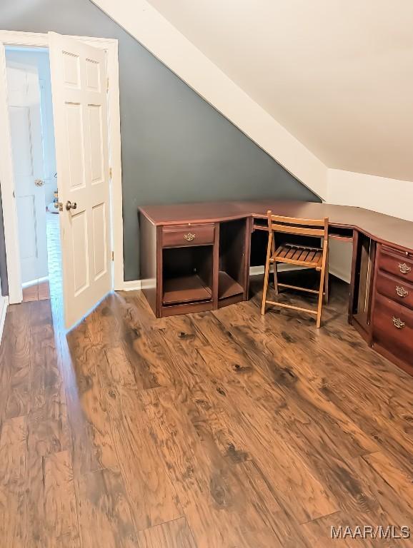 bonus room with hardwood / wood-style floors and vaulted ceiling