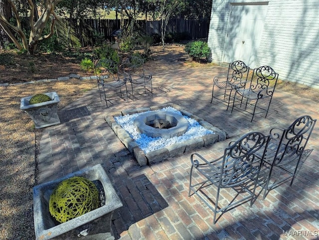 view of patio / terrace featuring a storage unit and an outdoor fire pit