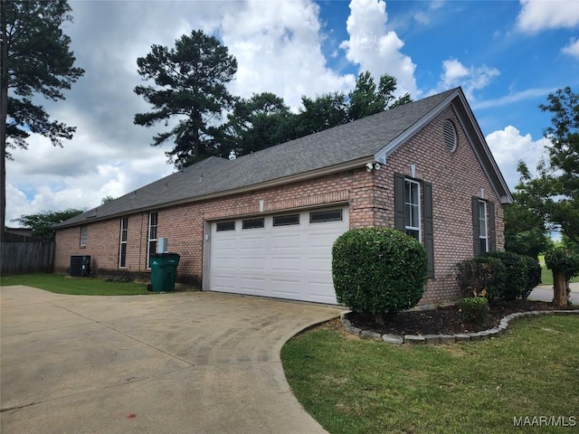 view of property exterior with central AC unit, a garage, and a lawn