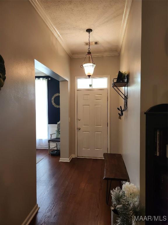 entryway with ornamental molding, a textured ceiling, and dark hardwood / wood-style flooring