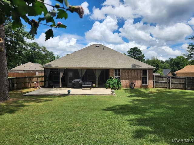 back of house featuring a yard and a patio