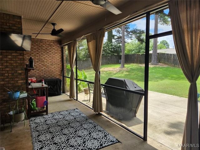 sunroom with a healthy amount of sunlight and ceiling fan