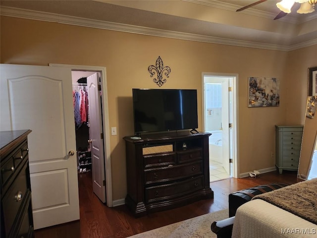 bedroom with dark hardwood / wood-style flooring, a walk in closet, crown molding, ensuite bath, and a closet