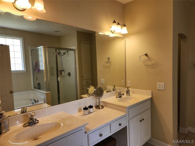 bathroom featuring vanity and shower with separate bathtub