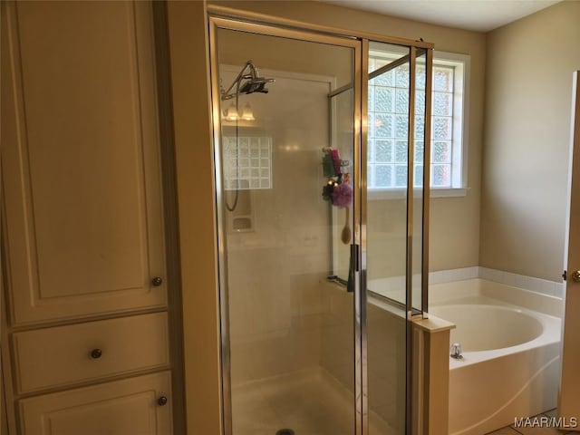 bathroom featuring separate shower and tub