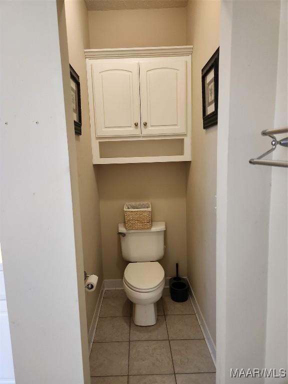 bathroom featuring tile patterned floors and toilet