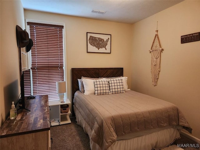 bedroom featuring dark carpet