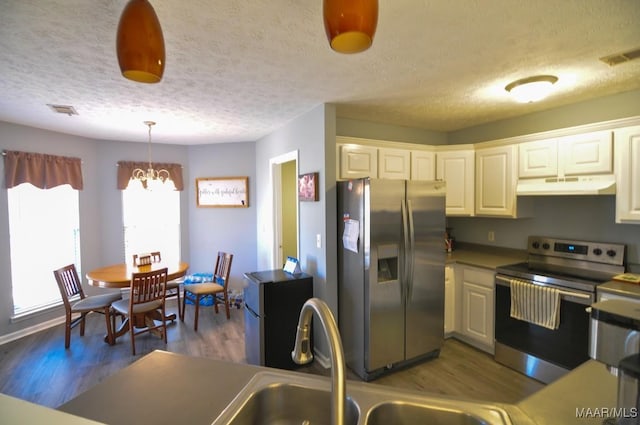 kitchen featuring sink, white cabinets, dark hardwood / wood-style flooring, hanging light fixtures, and stainless steel appliances