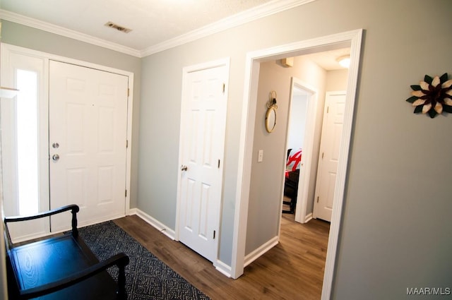 entryway featuring ornamental molding and dark hardwood / wood-style flooring