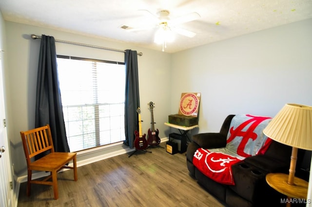 sitting room with hardwood / wood-style flooring and ceiling fan