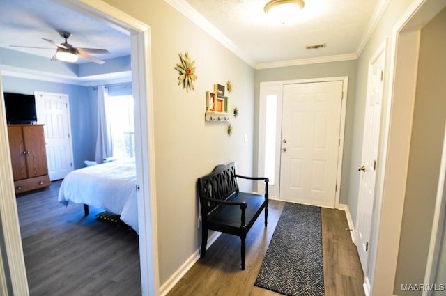 interior space with dark wood-type flooring, ceiling fan, and crown molding