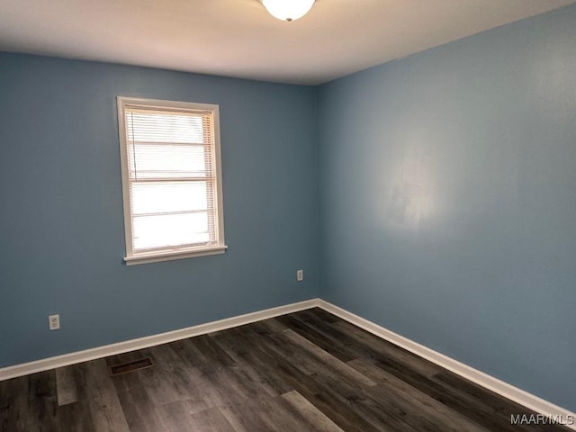 unfurnished room featuring dark hardwood / wood-style flooring