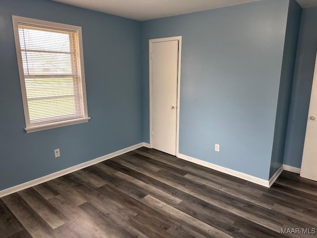 unfurnished room featuring dark hardwood / wood-style floors