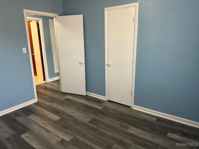 unfurnished bedroom featuring dark hardwood / wood-style flooring