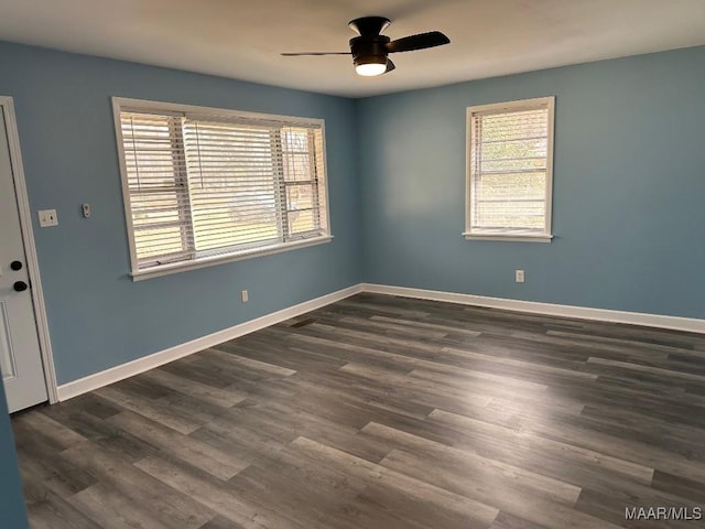 spare room featuring dark hardwood / wood-style floors and ceiling fan