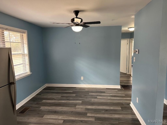 unfurnished room with dark hardwood / wood-style floors and ceiling fan