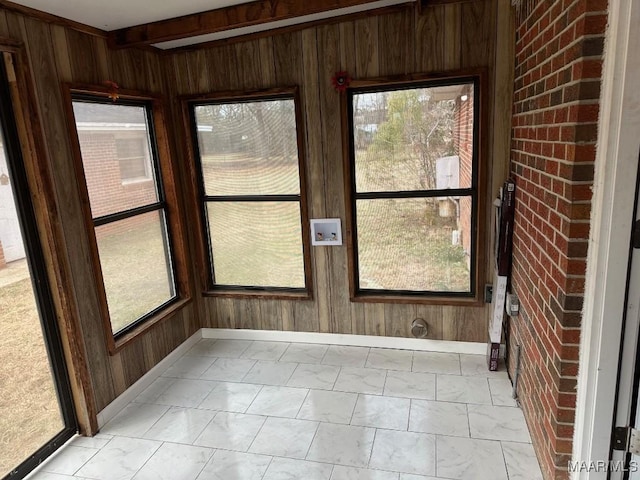 unfurnished sunroom featuring plenty of natural light