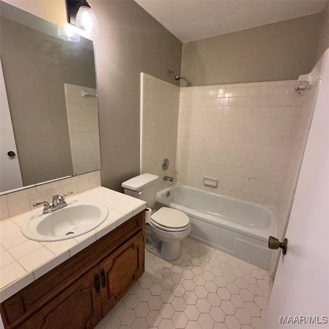 full bathroom with vanity, toilet, and tiled shower / bath