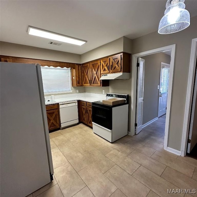 kitchen featuring electric stove, pendant lighting, dishwasher, and refrigerator