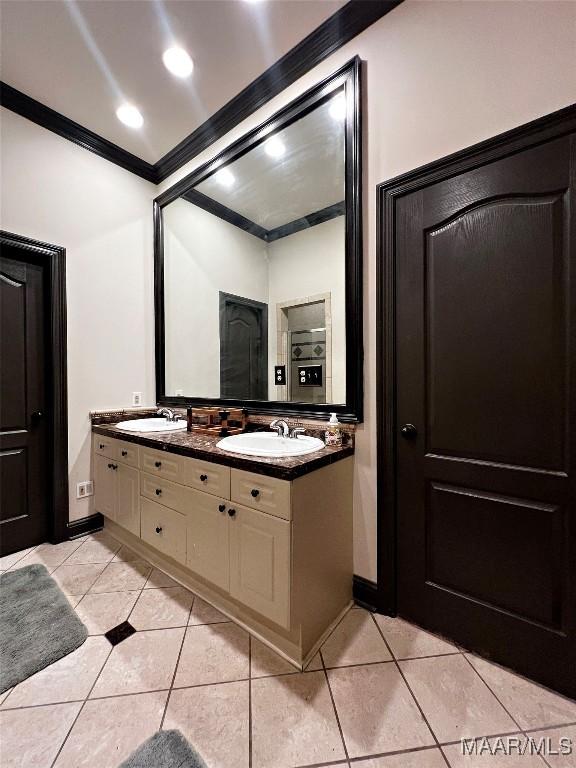 bathroom featuring ornamental molding, tile patterned floors, and vanity