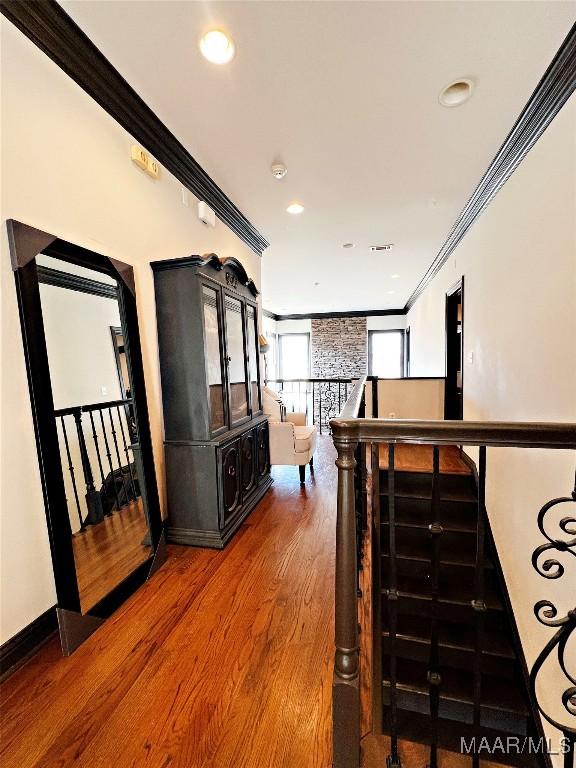 hall with crown molding and wood-type flooring