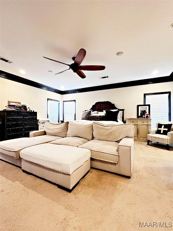 bedroom with crown molding, light colored carpet, ceiling fan, and multiple windows