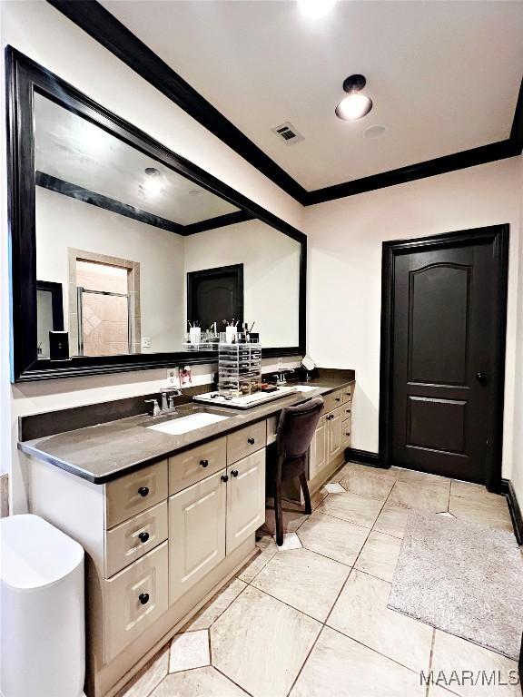 bathroom featuring crown molding and vanity