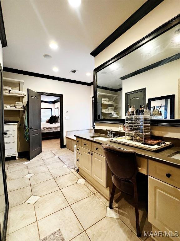 bathroom featuring tile patterned flooring, vanity, and ornamental molding