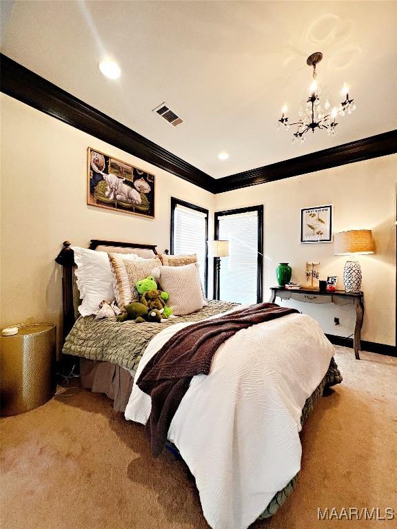 bedroom featuring crown molding, carpet flooring, and a chandelier