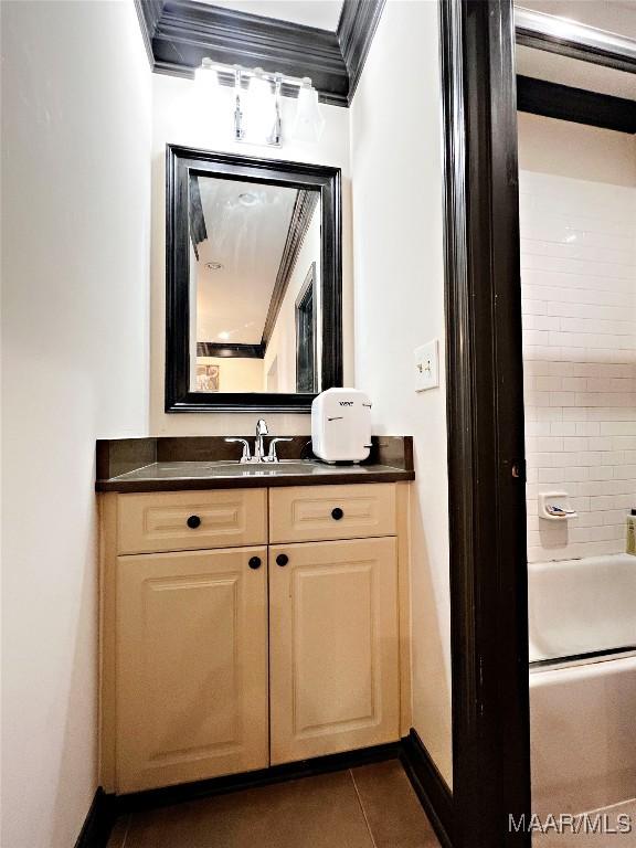 bathroom featuring tile patterned floors, vanity, tiled shower / bath combo, and ornamental molding