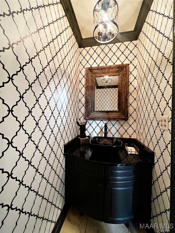 bathroom featuring tile patterned floors, ornamental molding, and vanity