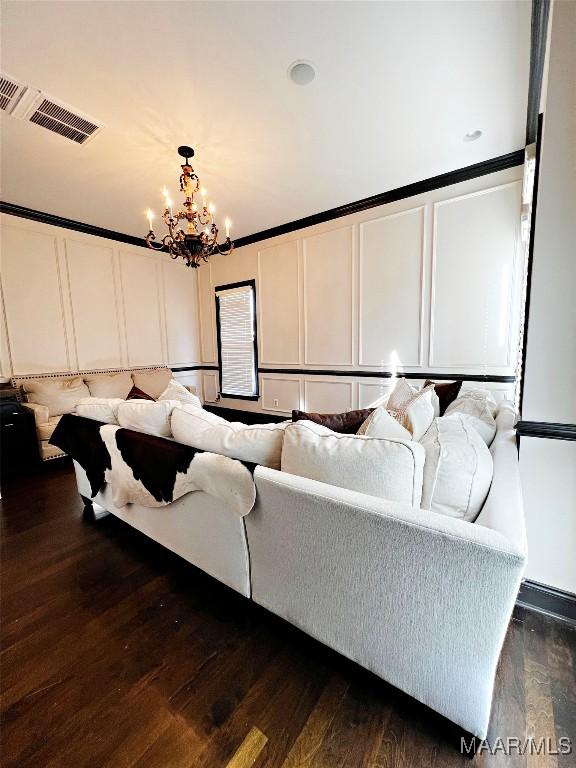 living room with dark wood-type flooring and a chandelier