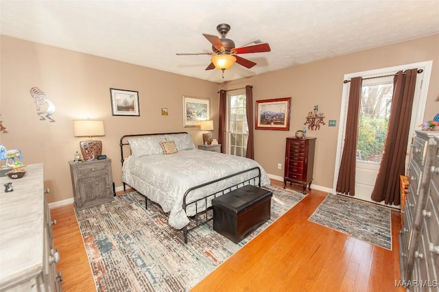 bedroom with hardwood / wood-style flooring and ceiling fan