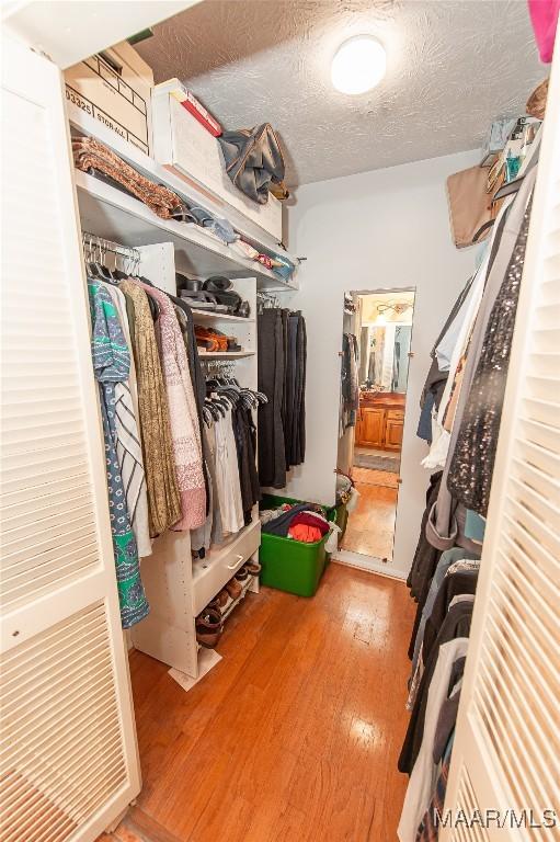 walk in closet featuring light hardwood / wood-style floors