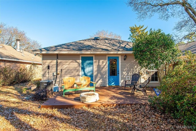 back of house featuring a deck and an outdoor fire pit